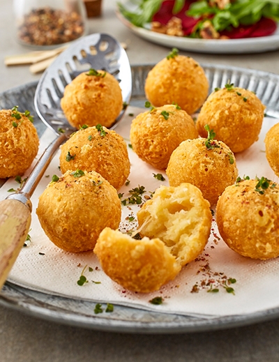 Crispy cheese puffs on arugula beetroot salad