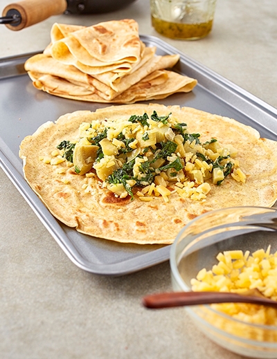 Spinach artichoke and gouda crepes with sweet honey sauce