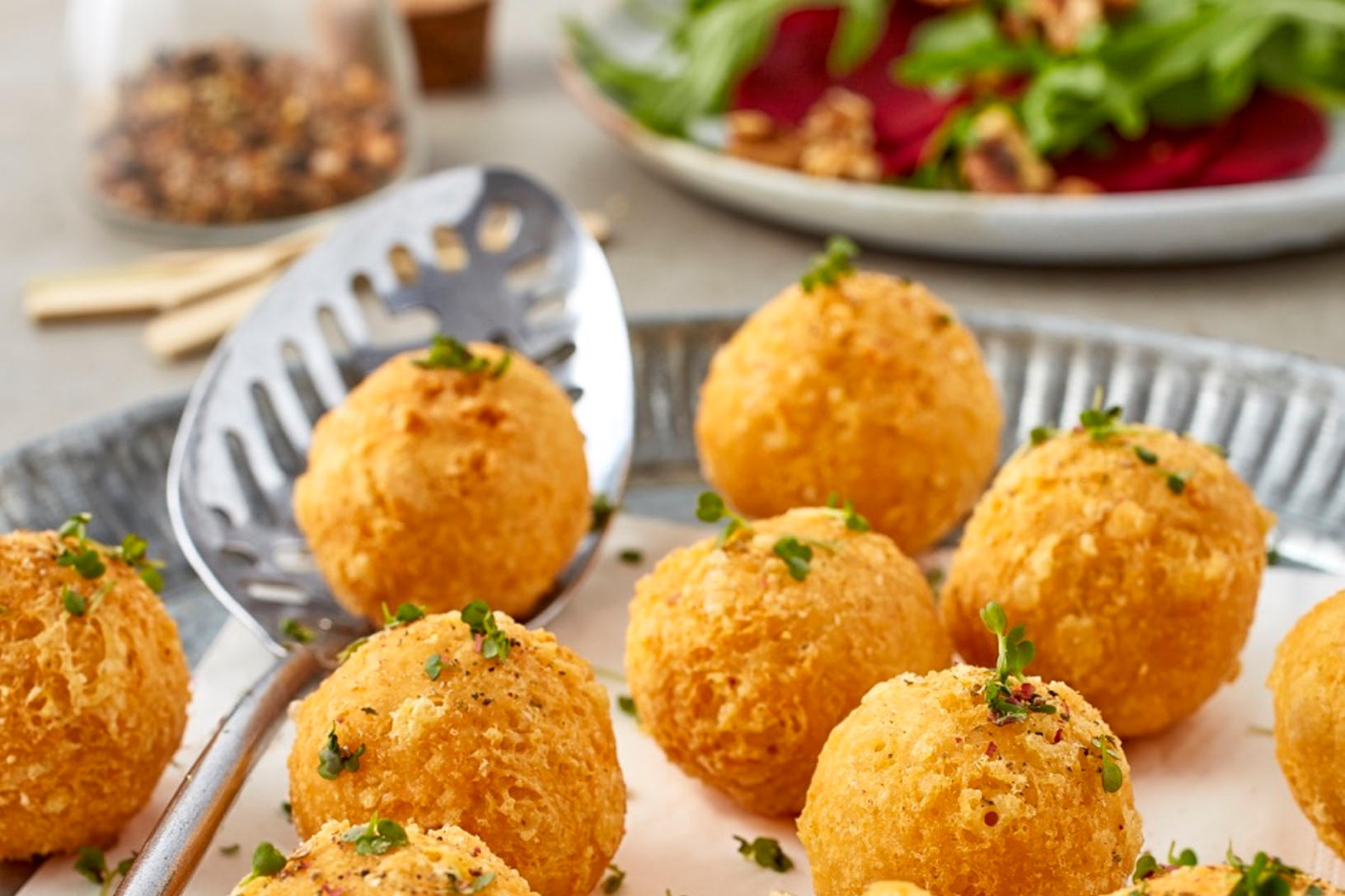 Crispy cheese puffs on arugula beetroot salad